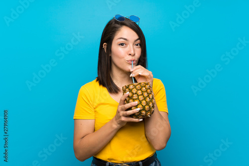 Young Mexican woman over isolated blue background