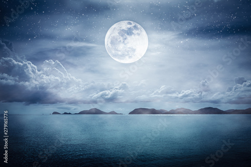 Beautiful sky with super moon over seascape. Serenity nature background.