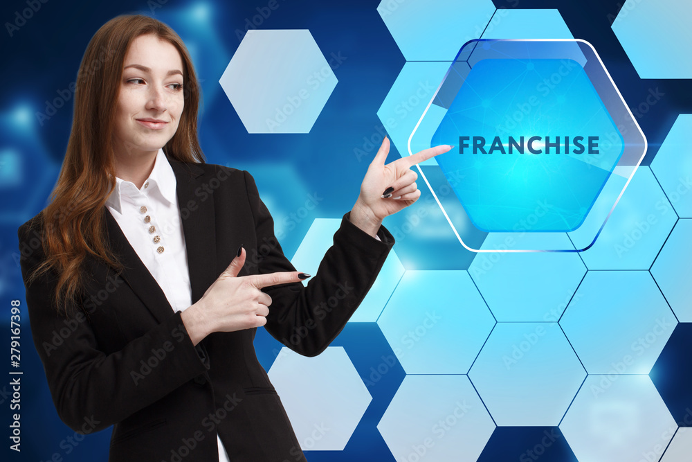 The concept of business, technology, the Internet and the network. A young entrepreneur working on a virtual screen of the future and sees the inscription: Franchise The concept of business, technology, the Internet and the network. A young entrepreneur working on a virtual screen of the future and sees the inscription: Franchise