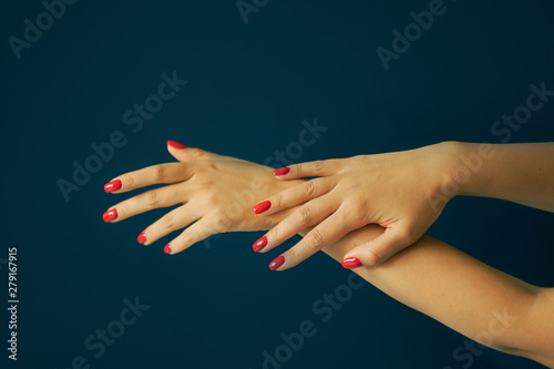 perfect red manicure. luxury nail and hand care in the salon. Black background