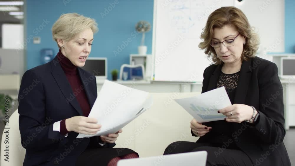 A female manager presents new project plan to colleagues at meeting, explaining ideas on flipchart to coworkers in office, businesswoman gives presentation, discussing ideas diverse business team. She A female manager presents new project plan to colleagues at meeting, explaining ideas on flipchart to coworkers in office, businesswoman gives presentation, discussing ideas diverse business team. She