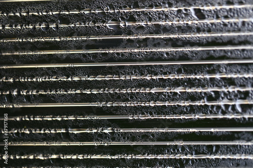 Water droplets on cellular polycarbonate, pattern and structure with variable scale and direction.