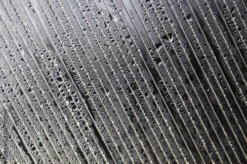 Water droplets on cellular polycarbonate, pattern and structure with variable scale and direction.