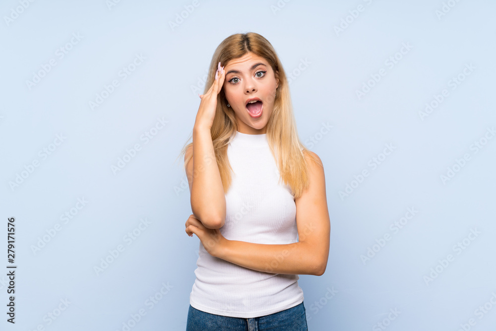 Teenager girl over isolated blue background proud and self-satisfied
