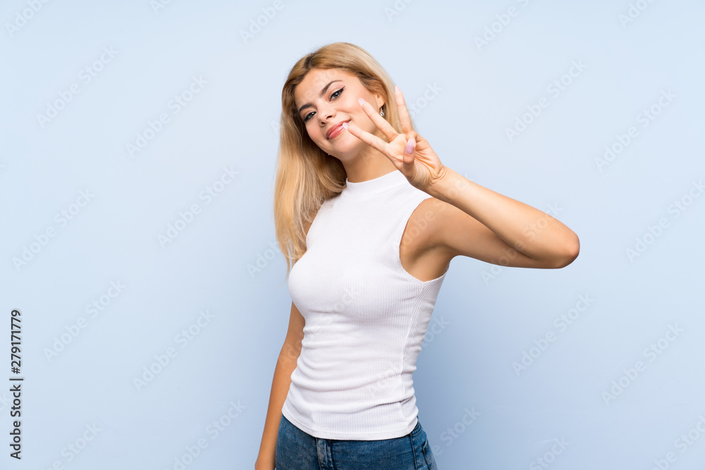 Teenager girl over isolated blue background making doubts gesture Teenager girl over isolated blue background making doubts gesture