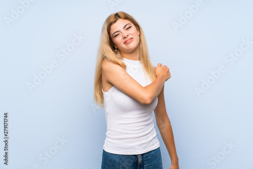 Teenager girl over isolated blue background showing and lifting a finger in sign of the best