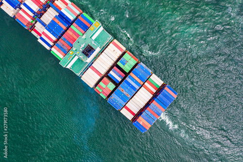 top aerial view of the large volume of TEU containers on ship sailing in the sea carriage the shipment from loading port to destination discharging port, transport and logistics services to worldwide