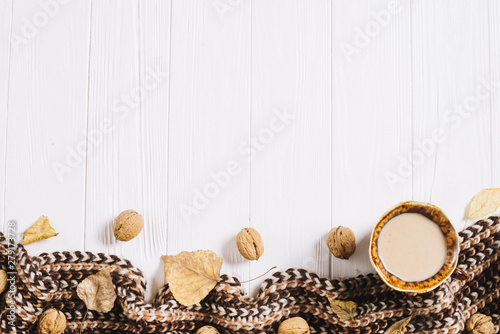 Leaves and nuts near drink and scarf