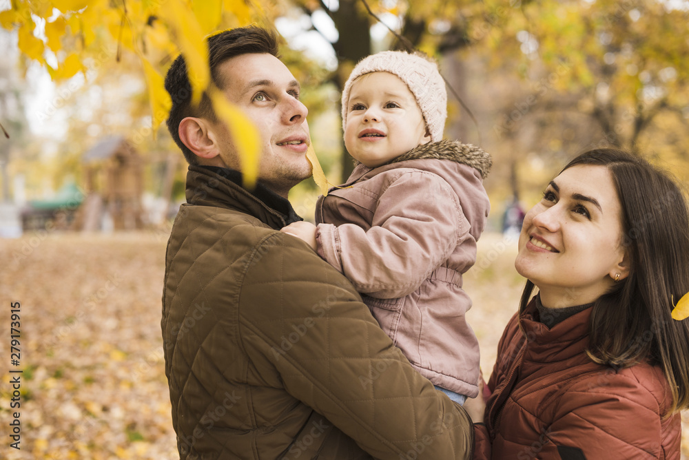 Family in park admiring of autumn nature Family in park admiring of autumn nature