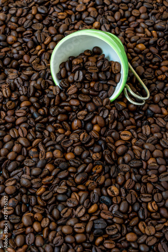 Green cup among a lot of coffee beans. © maramade