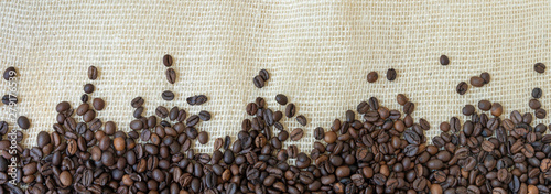 Texture of coffee beans with jute background.