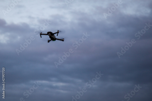 Drone in the sky. Unmanned aerial vehicle flying in the air