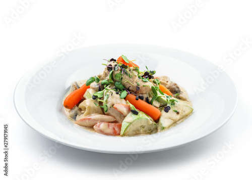 Hot salad with chicken meat, carrots, mushrooms, zucchini and cheese sauce isolated on white background. Healthy food, top view