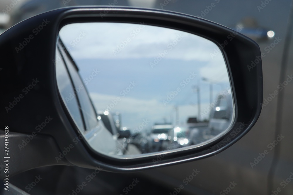 blurred of traffic jam in wing mirror of car on the road in summer day