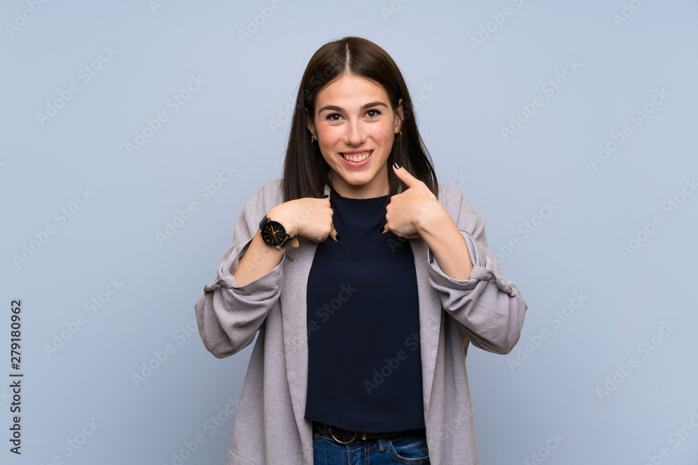 Young woman over isolated blue wall with surprise facial expression Young woman over isolated blue wall with surprise facial expression