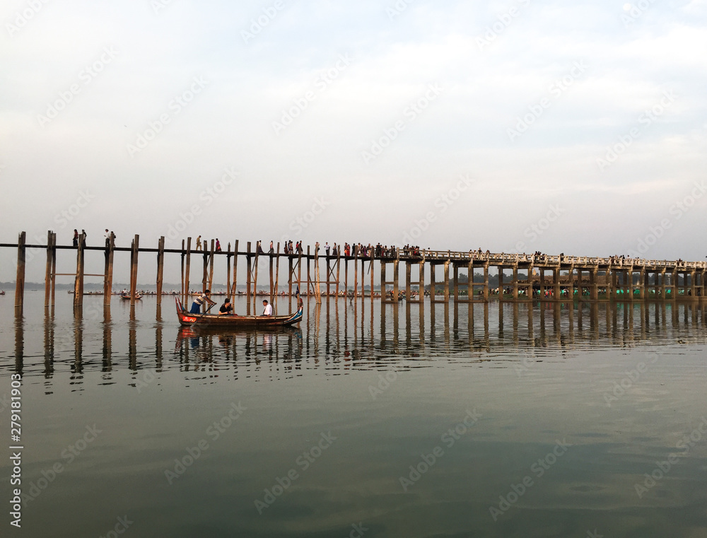 People visit U Bein Bridge by boat