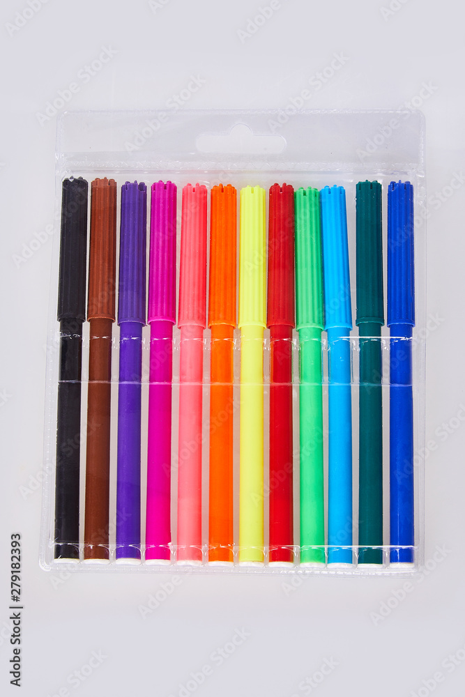 Close-up view of set of colorful felt tip pens in transparent plastic packaging isolated on white backgroundisolated on white background. Multicolored soft-tip markers Close-up view of set of colorful felt tip pens in transparent plastic packaging isolated on white backgroundisolated on white background. Multicolored soft-tip markers