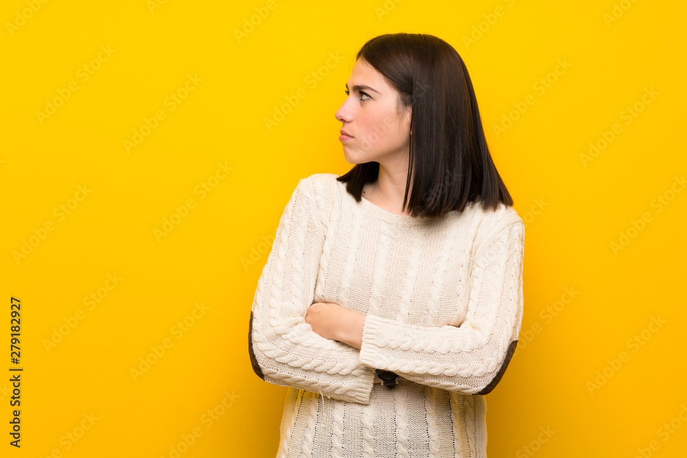 Young woman over isolated yellow wall portrait Young woman over isolated yellow wall portrait