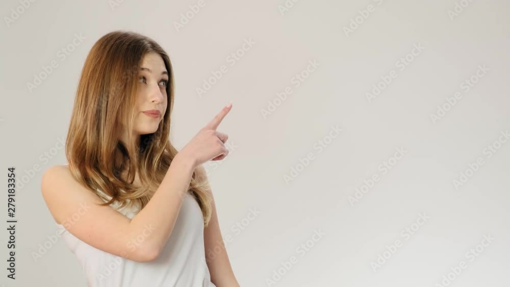 Serious young woman showing denying gesture and looking at camera while standing isolated over gray background slow motion Serious young woman showing denying gesture and looking at camera while standing isolated over gray background slow motion