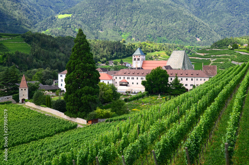 Novacella Monastery surrounded by green wineyards, South Tyrol, Bressanone, Italy.
