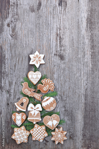 Gingerbread with christmas tree on wooden background 
