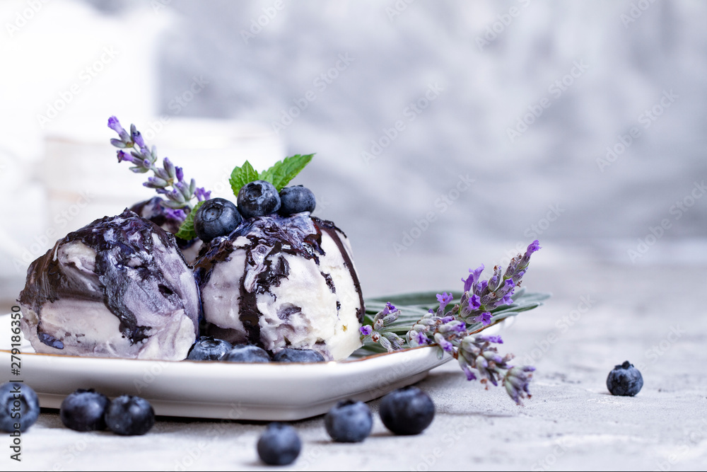 Vanila and blueberry ice cream with lavender on blue background. Fresh vitamin nutrition. Natural vegetarian healthy food. Ice cream decoration. Summer background. Vegetarian product. Nature design. - obrazy, fototapety, plakaty 