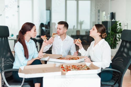 business people having pizza lunch in the office
