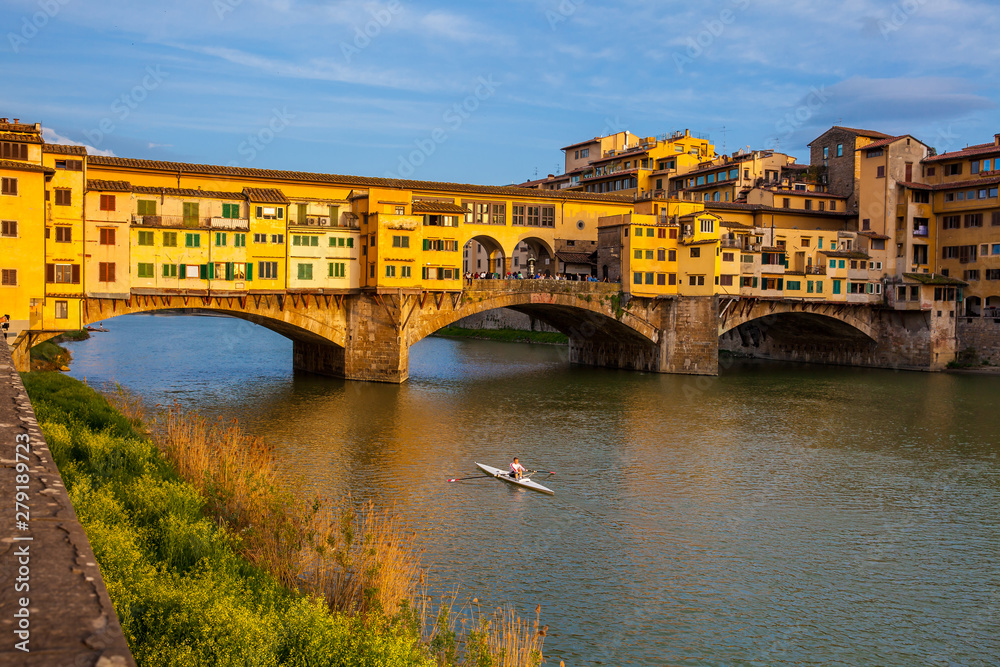 Golden hour at the Ponte Vecchio a medieval stone closed-spandrel segmental arch bridge over the Arno River in Florence