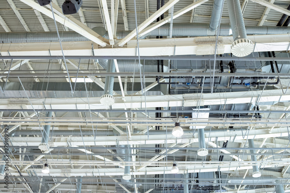 Supply and exhaust ventilation system on the ceiling in the exhibition hall. Lighting in the warehouse.