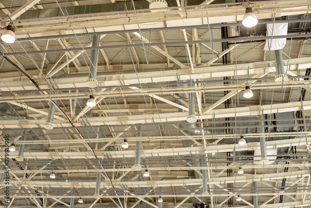 Supply and exhaust ventilation system on the ceiling in the exhibition hall. Lighting in the warehouse.