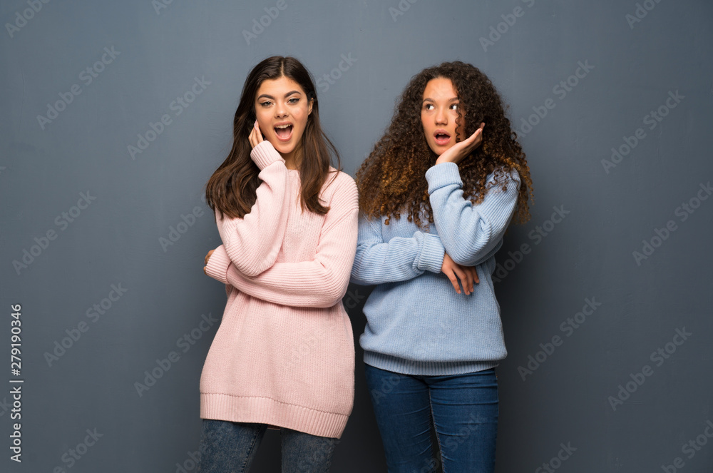 Teenager friends surprised and shocked while looking right Teenager friends surprised and shocked while looking right