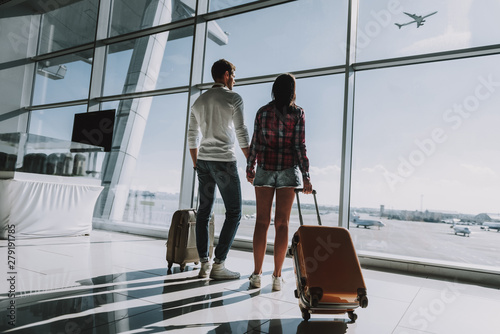 Loving couple is waiting for flight at airport photo