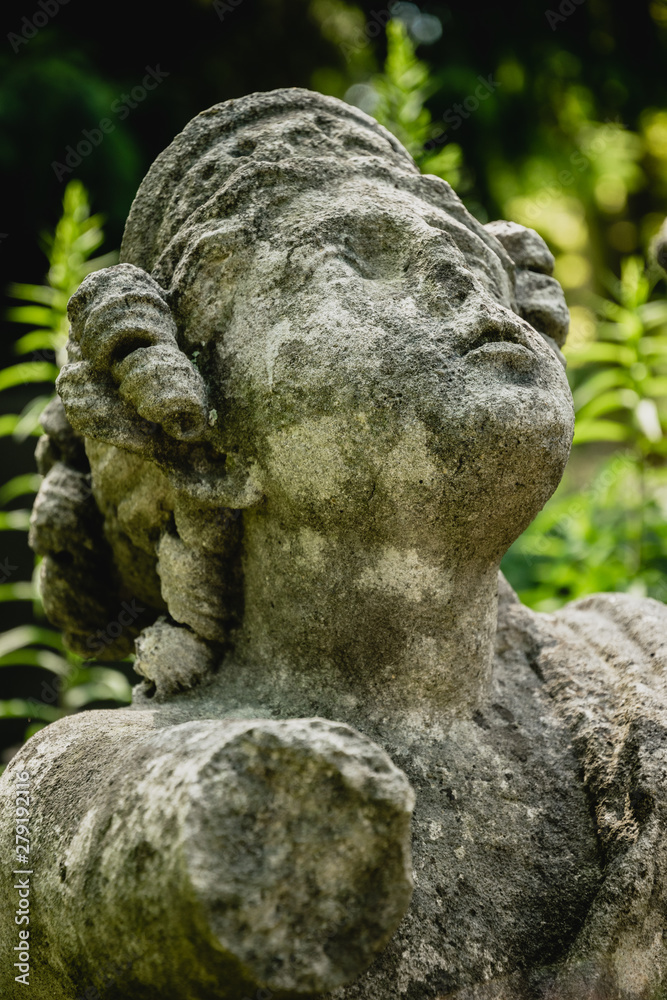 Marble statue and an ancient abandoned Gothic cemetery