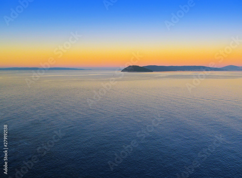 Beautiful morning panorama of Adriatic sea near Split  Croatia. A panoramic view at dawn of a water  sky with a dawning  silhouette of coastline of islands. Nautical landscape of bay in West Europe.