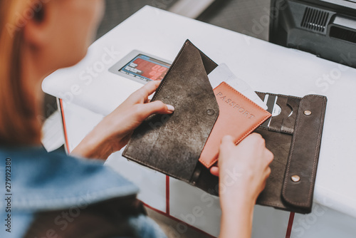 Young woman keeping in arms her documents for departure photo