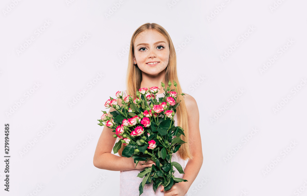 Beautiful, cute, lovely, smiling blonde little girl with happy eyes holds large bouquet of flowers isolated in studio. Birthday, holidays, Valentines day, mothers day concepts. Beautiful, cute, lovely, smiling blonde little girl with happy eyes holds large bouquet of flowers isolated in studio. Birthday, holidays, Valentines day, mothers day concepts.