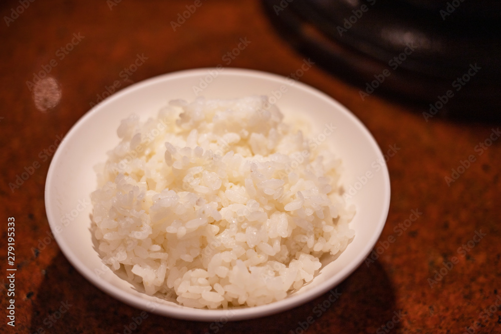 Japanese white rice in white bowl on table Japanese white rice in white bowl on table