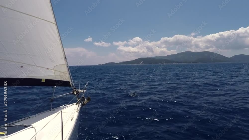 Front bow of a sailboat open sails in the calm sea Front bow of a sailboat open sails in the calm sea