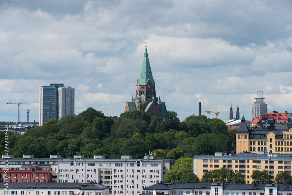 View over the island Djurgården, old town and district Södermalm with ferries and commuting boats in Stockholm.