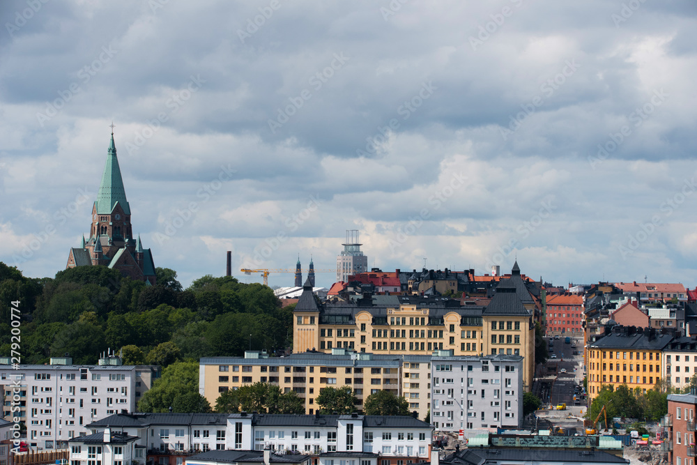 View over the island Djurgården, old town and district Södermalm with ferries and commuting boats in Stockholm.