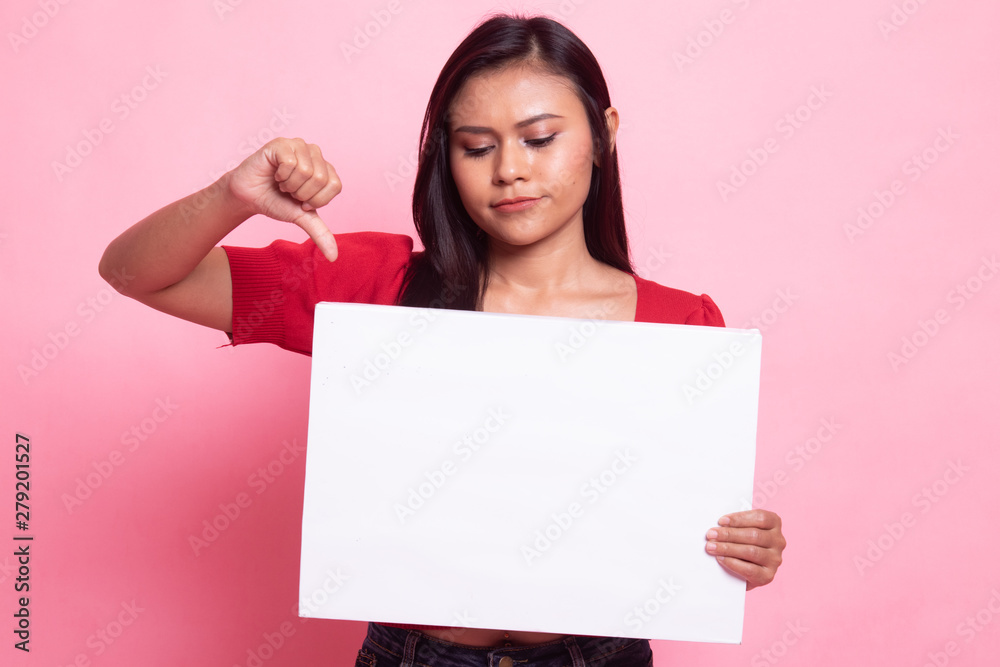 Young Asian woman show thumbs down with white blank sign. Young Asian woman show thumbs down with white blank sign.