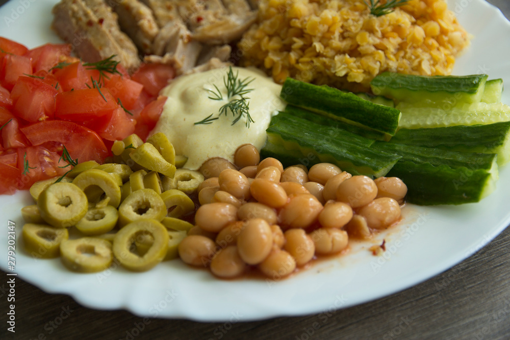 Lentils, chicken, olives,white beans, cucumbers, tomatoes and sauce
