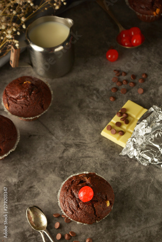 Chocolate muffins on dark background. Milk and chocolate.