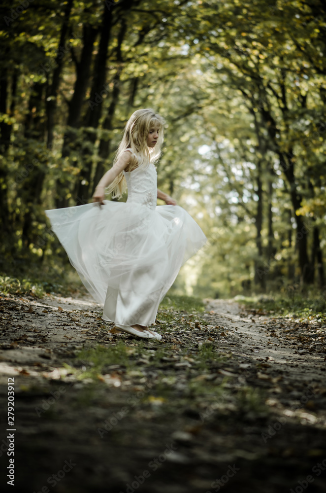 adorable blond girl dancing in sunny day in magical forest adorable blond girl dancing in sunny day in magical forest