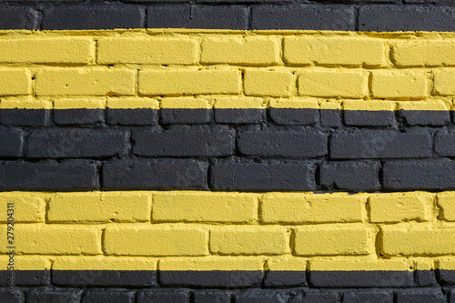 Brick wall painted in yellow and black