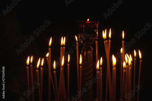 Candles are burning, stand in the church candlestick in the dark