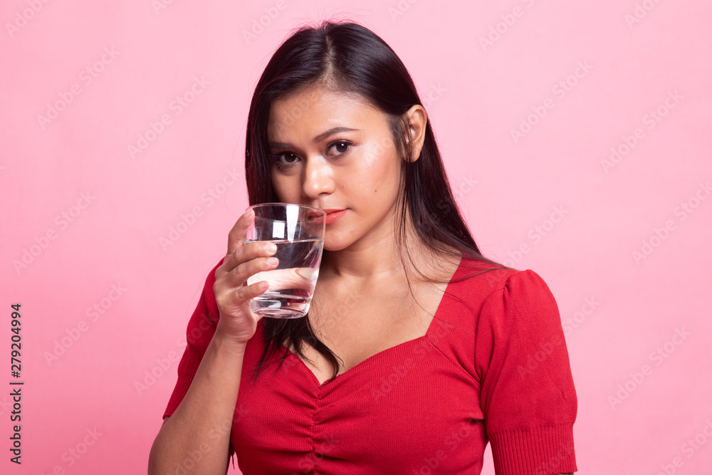 Young Asian woman with a glass of drinking water.
