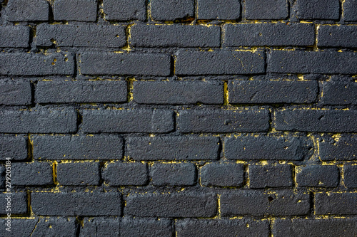 Brick wall painted in yellow and black