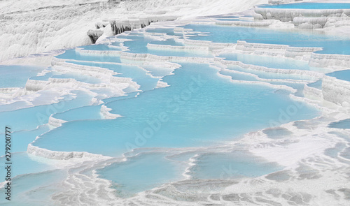 Natural travertine pools and terraces view from Pamukkale  Denizli  Turkey. Cotton castle at sunny bright day.