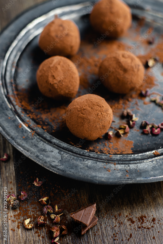 dark chocolate candy truffles with sichuan pepper on dark background dark chocolate candy truffles with sichuan pepper on dark background